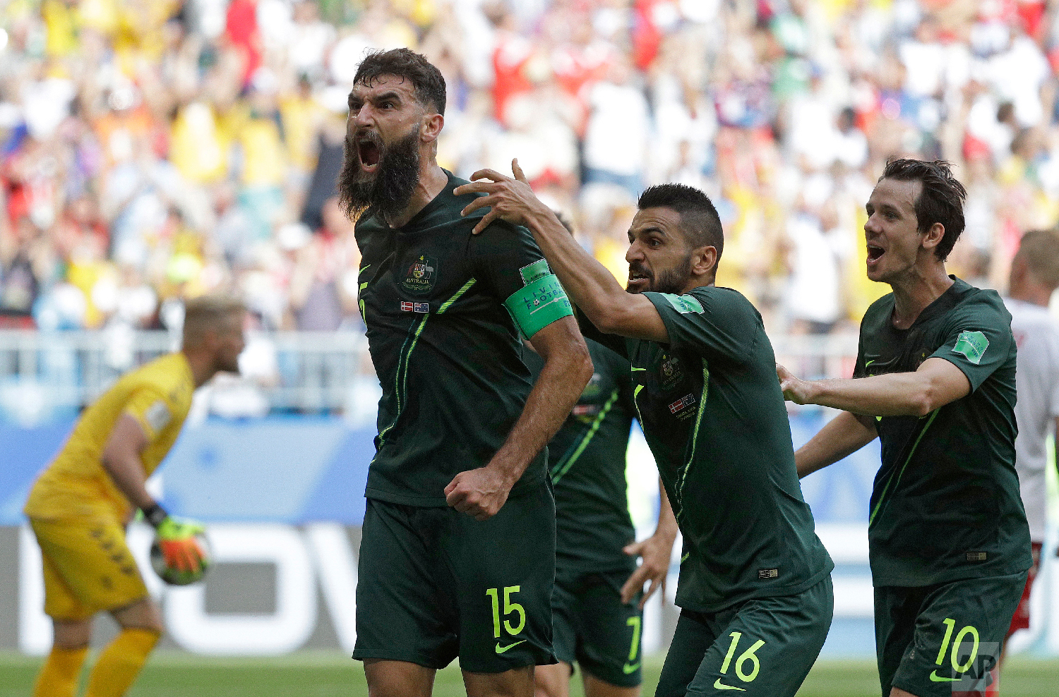 Australia's Mile Jedinak celebrates scoring his side's opening goal during the group C match between Denmark and Australia at the 2018 soccer World Cup in the Samara Arena in Samara, Russia, Thursday, June 21, 2018. (AP Photo/Gregorio Borgia)
