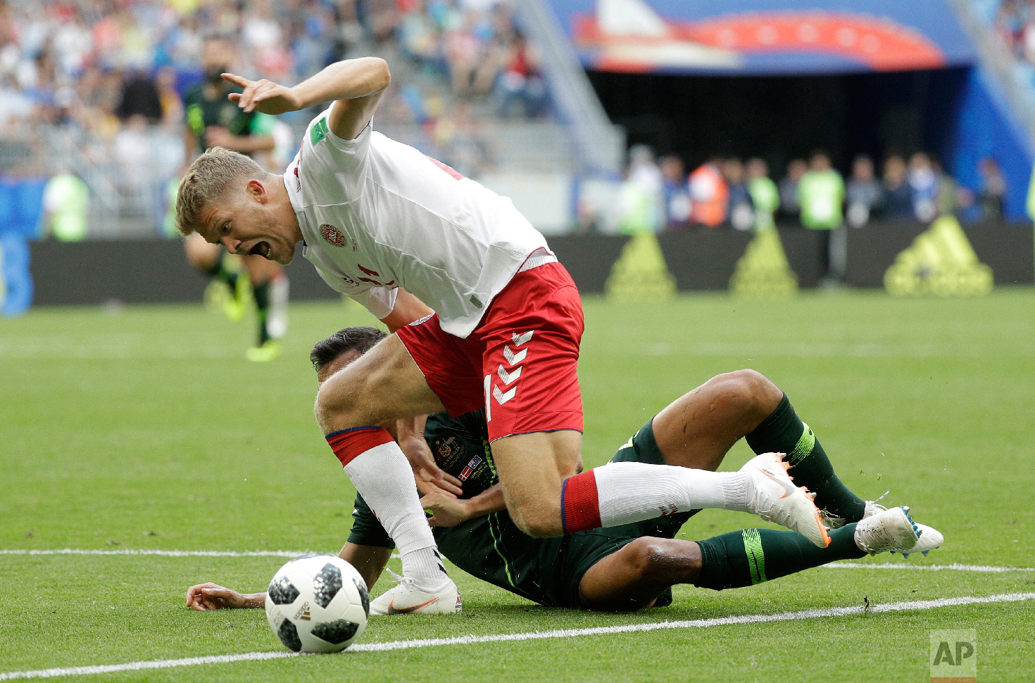 Denmark's Andreas Cornelius, right, shouts out after a challenge from Australia's Trent Sainsbury during the group C match between Denmark and Australia at the 2018 soccer World Cup in the Samara Arena in Samara, Russia, Thursday, June 21, 2018. (AP Photo/Gregorio Borgia)
