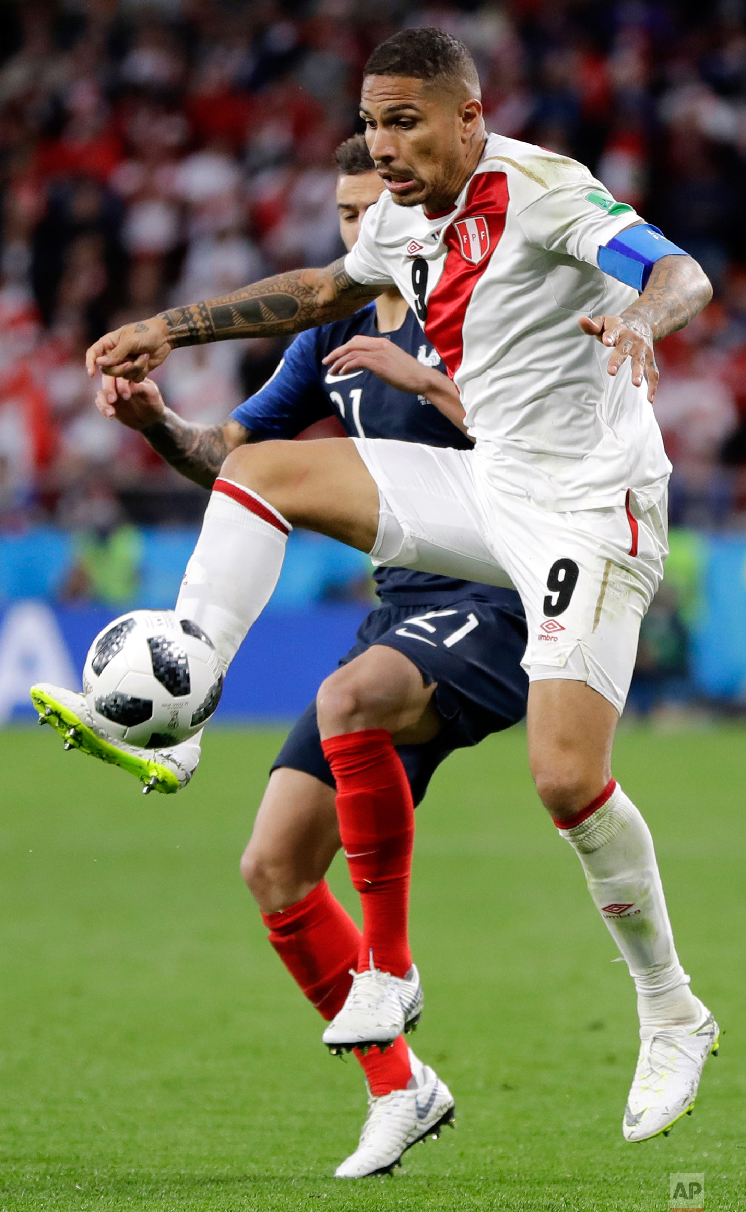Peru's Paolo Guerrero is challenged by France's Lucas Hernandez, background, during the group C match between France and Peru at the 2018 soccer World Cup in the Yekaterinburg Arena in Yekaterinburg, Russia, Thursday, June 21, 2018. (AP Photo/Natach