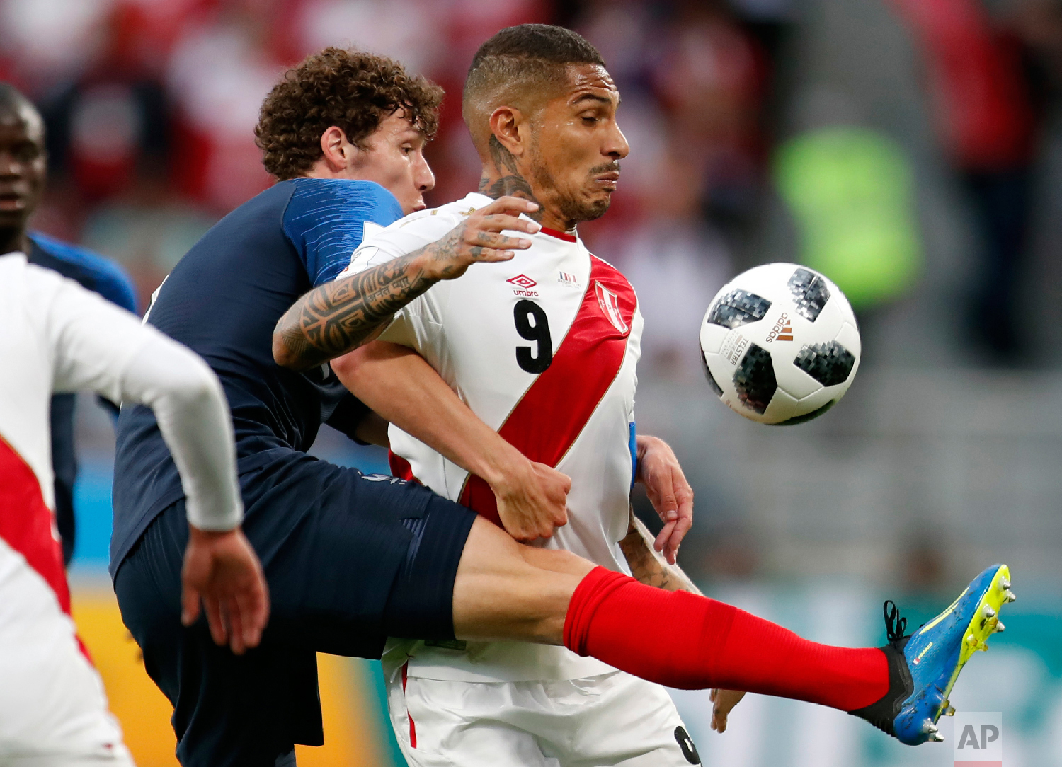 Peru's Pablo Guerrero, right, is challenged by France's Benjamin Pavard during the group C match between France and Peru at the 2018 soccer World Cup in the Yekaterinburg Arena in Yekaterinburg, Russia, Thursday, June 21, 2018. (AP Photo/Natacha Pisarenko)