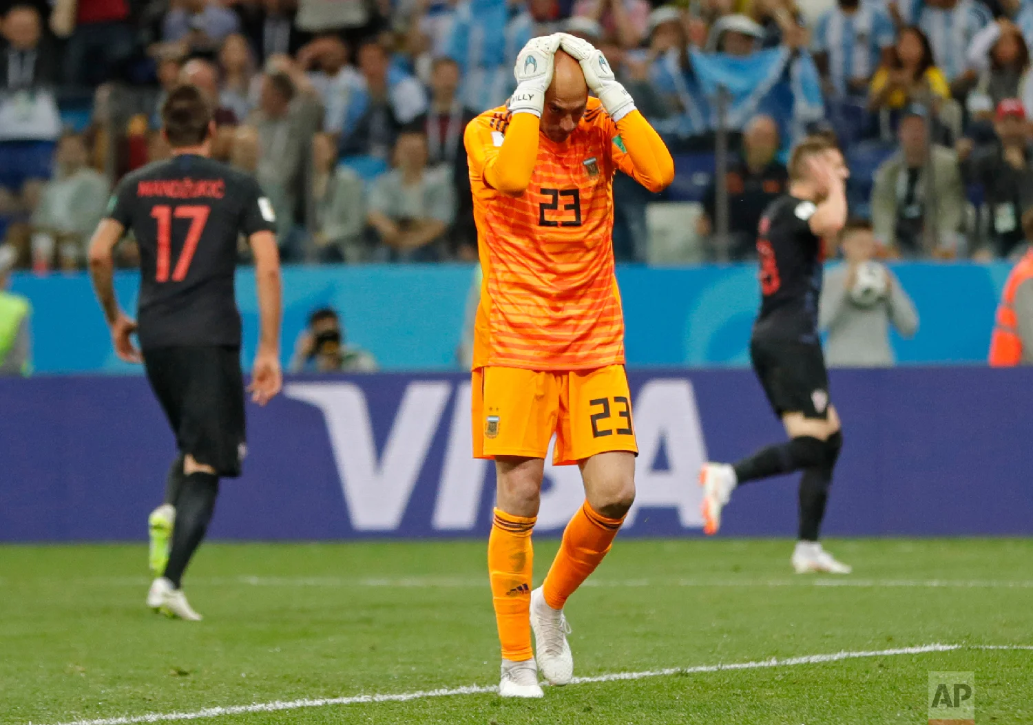 Argentina goalkeeper Wilfredo Caballero holds his head after Croatia's Ante Rebic, background right, scored the opening goal during the group D match between Argentina and Croatia at the 2018 soccer World Cup in Nizhny Novgorod Stadium in Nizhny Nov