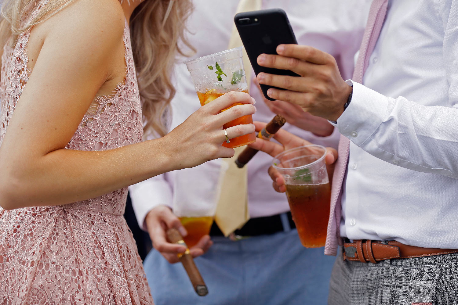  Racegoers enjoy drinks and cigars on the second day of the Royal Ascot horse race meeting in Ascot, England, Wednesday, June 20, 2018. (AP Photo/Tim Ireland) 