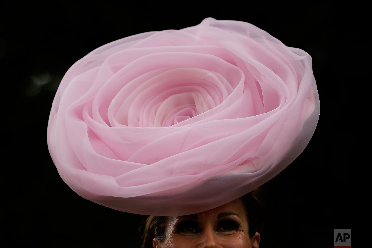  A racegoer poses for photographers on the first day of the Royal Ascot horse race meeting in Ascot, England, Tuesday, June 19, 2018. (AP Photo/Tim Ireland) 