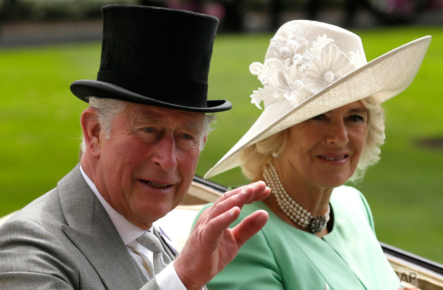  The Prince of Wales and the Duchess of Cornwal arrive at the parade ring in a horse drawn carriage, on the second day of the Royal Ascot horse race meeting in Ascot, England, Wednesday, June 20, 2018. (AP Photo/Tim Ireland) 