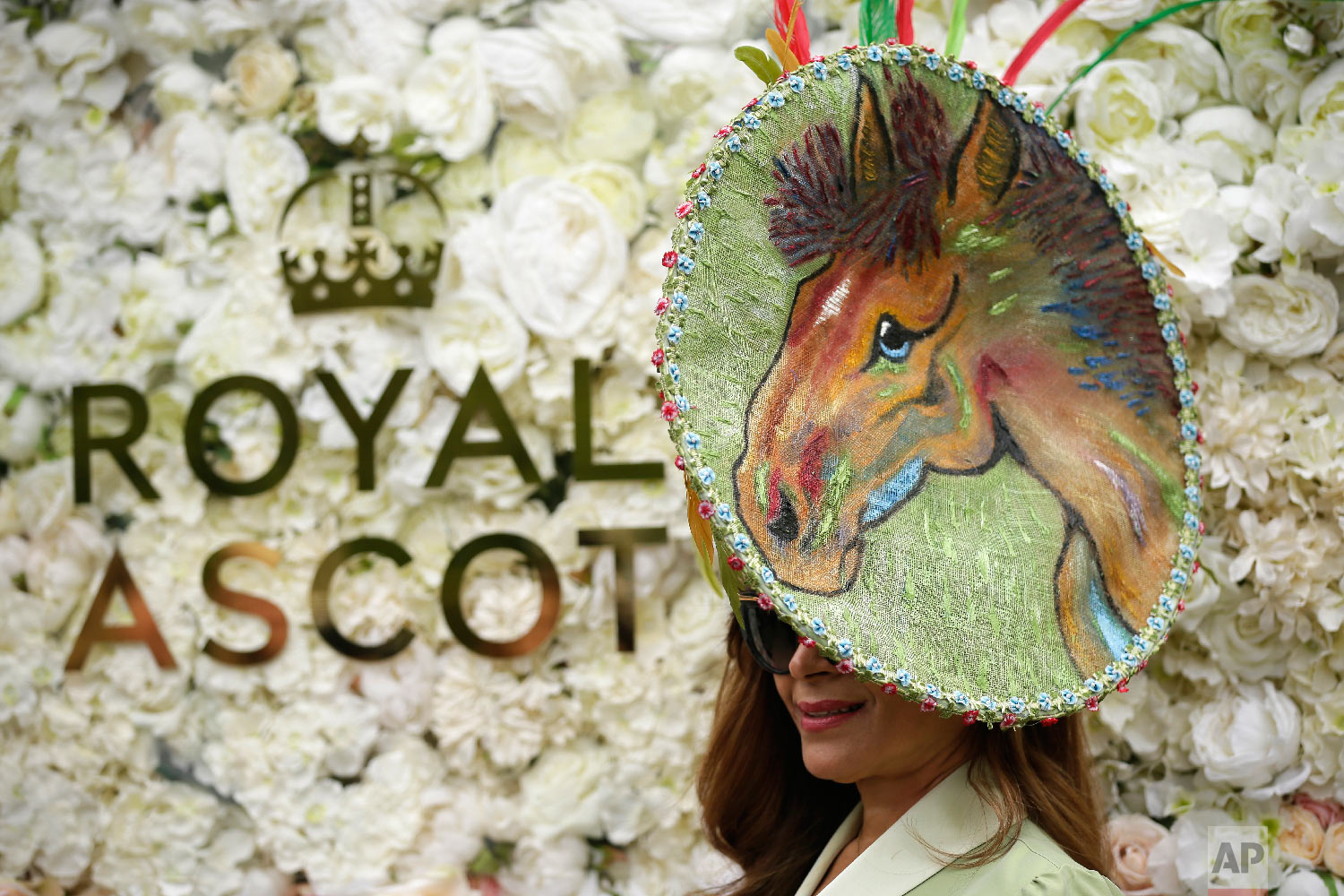  A racegoer poses for photographers on the first day of the Royal Ascot horse race meeting in Ascot, England, Tuesday, June 19, 2018. (AP Photo/Tim Ireland) 