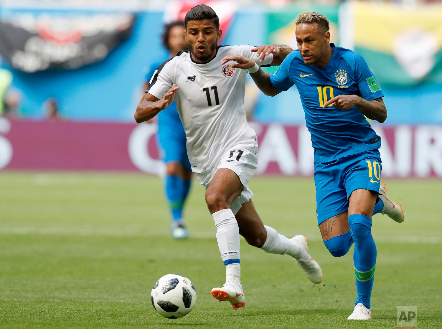 Brazil's Neymar takes the ball past Costa Rica's Johan Venegas, left, during the group E match between Brazil and Costa Rica at the 2018 soccer World Cup in the St. Petersburg Stadium in St. Petersburg, Russia, Friday, June 22, 2018. (AP Photo/Alastair Grant)