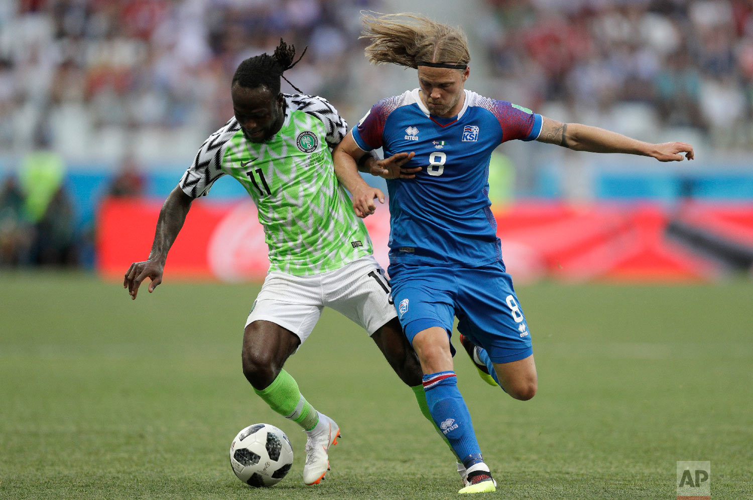 Nigeria's Victor Moses, left, and Iceland's Birkir Bjarnason challenge for the ball during the group D match between Nigeria and Iceland at the 2018 soccer World Cup in the Volgograd Arena in Volgograd, Russia, Friday, June 22, 2018. (AP Photo/Andrew Medichini)