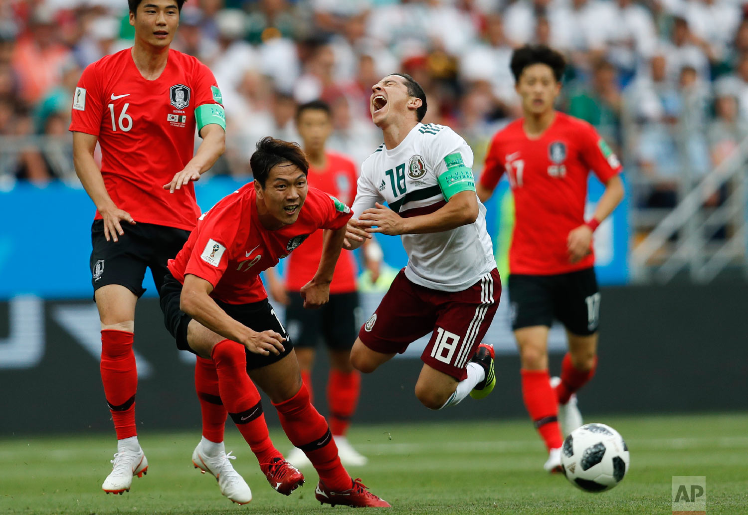 Mexico's Andres Guardado, right, challenges for the ball with South Korea's Kim Young-gwon during the group F match between Mexico and South Korea at the 2018 soccer World Cup in the Rostov Arena in Rostov-on-Don, Russia, Saturday, June 23, 2018. (AP Photo/Eduardo Verdugo)