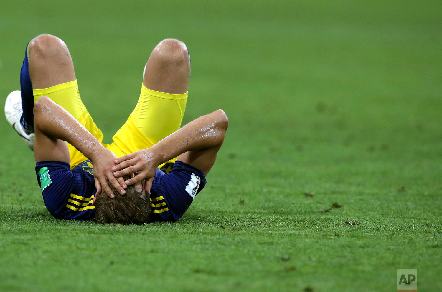 Sweden's Ludwig Augustinsson holds his head as he lies on the pitch at the end of the group F match between Germany and Sweden at the 2018 soccer World Cup in the Fisht Stadium in Sochi, Russia, Saturday, June 23, 2018. Germany won 2-1. (AP Photo/Thanassis Stavrakis)