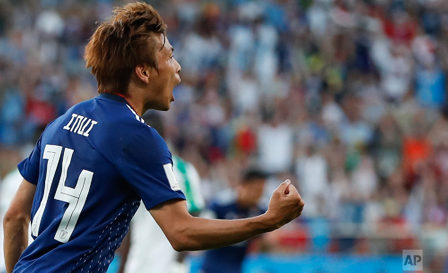 Japan's Takashi Inui celebrates after he scored his side's first goal during the group H match between Japan and Senegal at the 2018 soccer World Cup at the Yekaterinburg Arena in Yekaterinburg , Russia, Sunday, June 24, 2018. (AP Photo/Natacha Pisarenko)