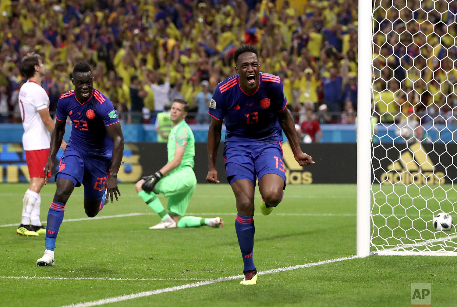 Colombia's scorer Yerry Mina, right and his teammate Davinson Sanchez, left, celebrate the opening goal during the group H match between Poland and Colombia at the 2018 soccer World Cup at the Kazan Arena in Kazan, Russia, Sunday, June 24, 2018. (AP Photo/Thanassis Stavrakis)