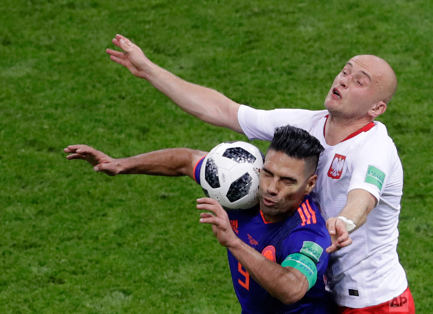 Colombia's Radamel Falcao, left, and Poland's Michal Pazdan battle for the ball during the group H match between Poland and Colombia at the 2018 soccer World Cup at the Kazan Arena in Kazan, Russia, Sunday, June 24, 2018. (AP Photo/Sergei Grits)