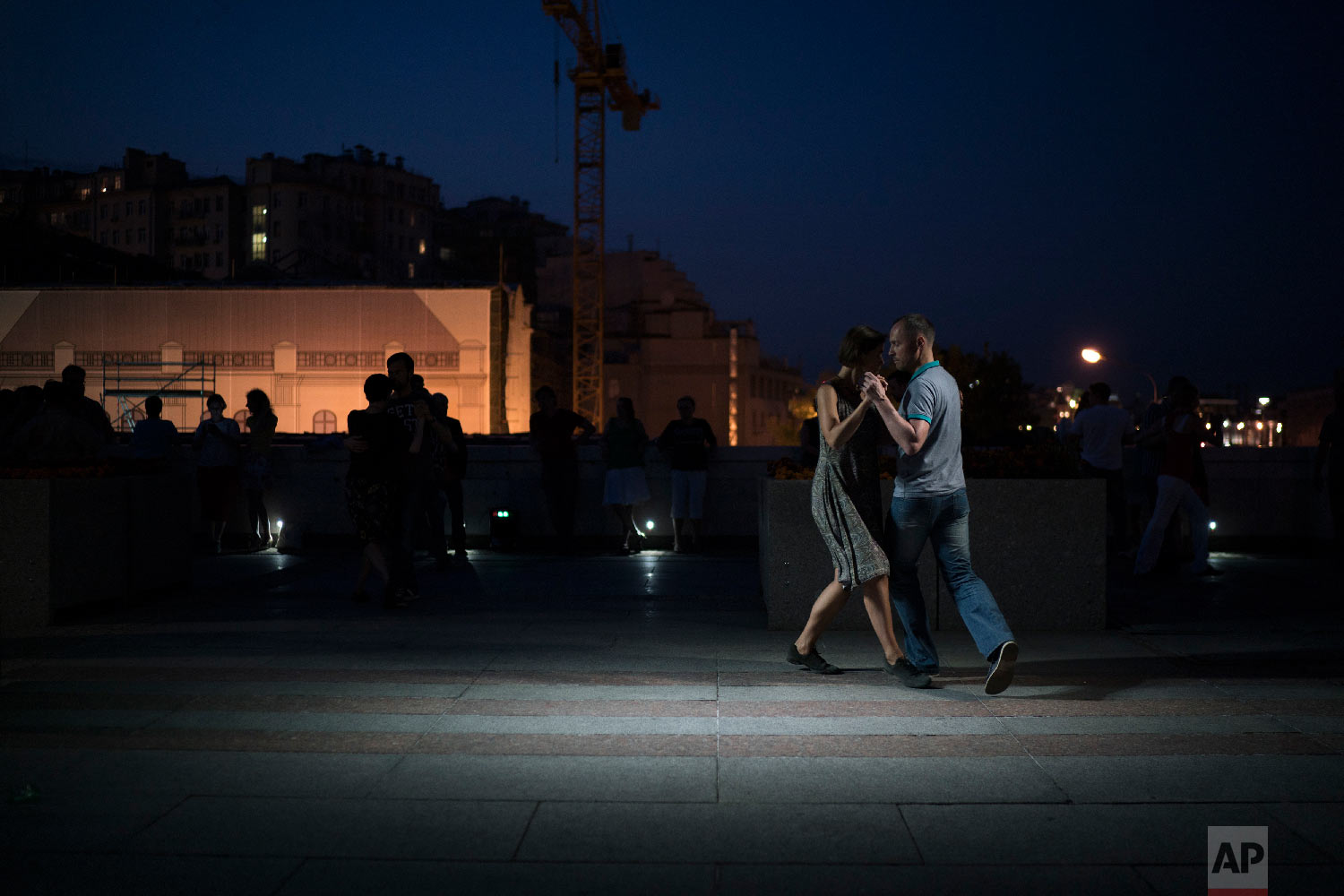 A couple dances tango on a bridge in central Moscow, during the 2018 soccer World Cup in Russia on June 22, 2018. (AP Photo/Felipe Dana)