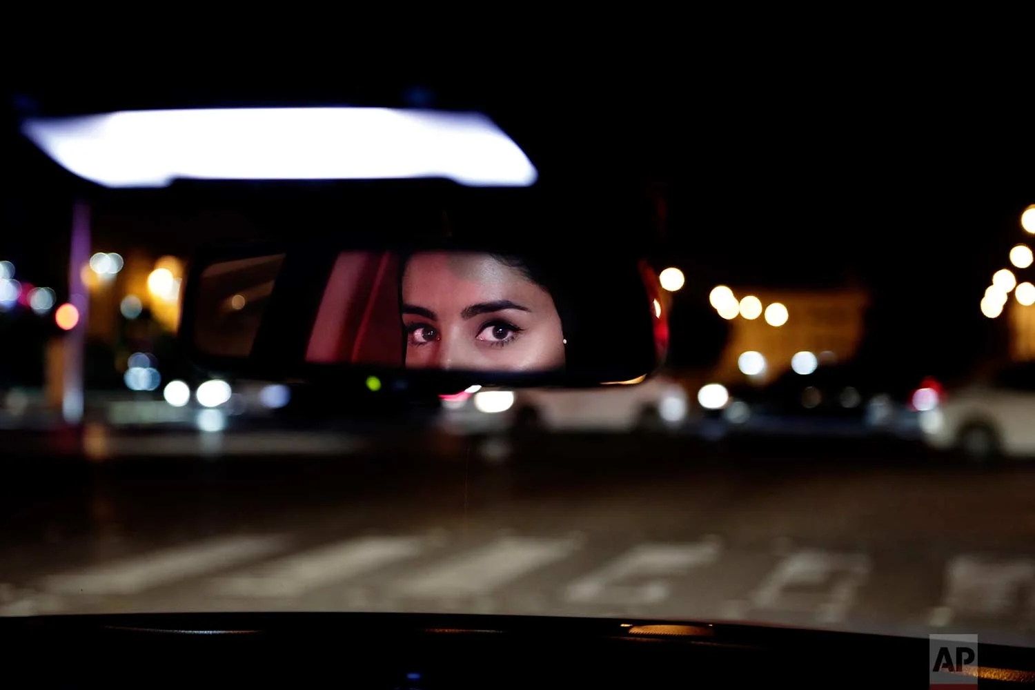 In this Sunday, June 24, 2018 photo, Hessah al-Ajaji drives her car down the capital's busy Tahlia Street after midnight for the first time, in Riyadh, Saudi Arabia. (AP Photo/Nariman El-Mofty)