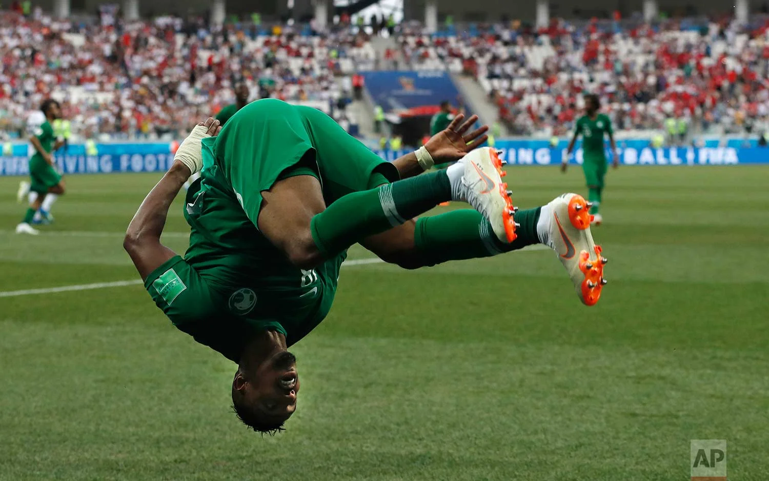 Saudi Arabia's Salem Aldawsari celebrates with a flip after scoring his side's second goal during the group A match between Saudi Arabia and Egypt at the 2018 soccer World Cup at the Volgograd Arena in Volgograd, Russia, Monday, June 25, 2018. (AP Photo/Darko Vojinovic)