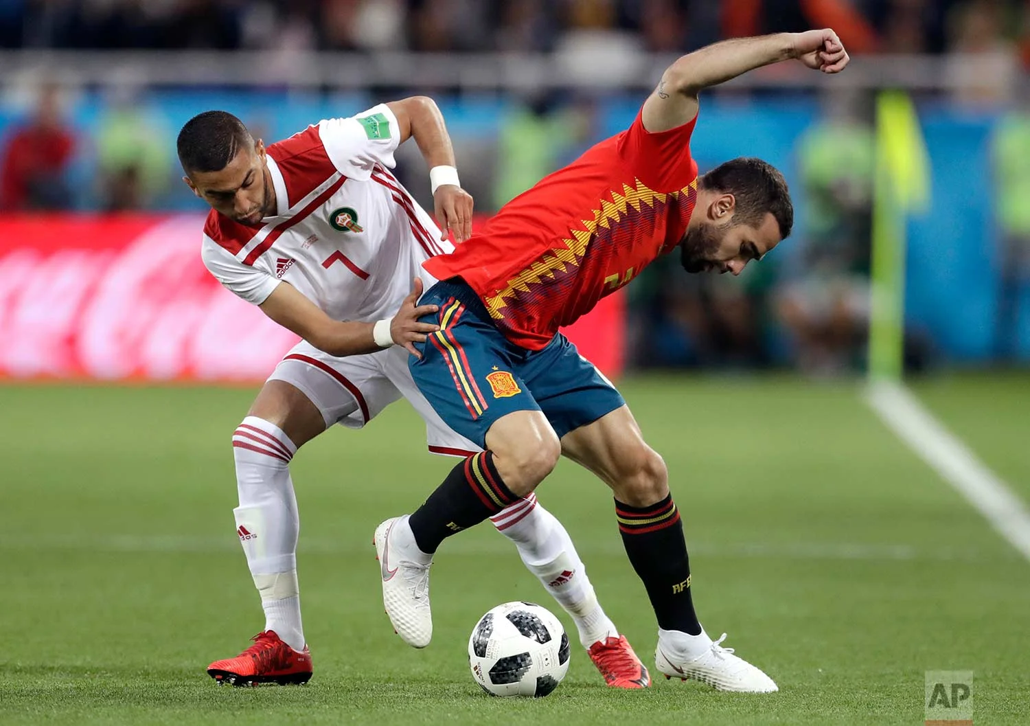 Morocco's Hakim Ziyach, left, challenges for the ball with Spain's Dani Carvajal during the group B match between Spain and Morocco at the 2018 soccer World Cup at the Kaliningrad Stadium in Kaliningrad, Russia, Monday, June 25, 2018. (AP Photo/Petr David Josek)