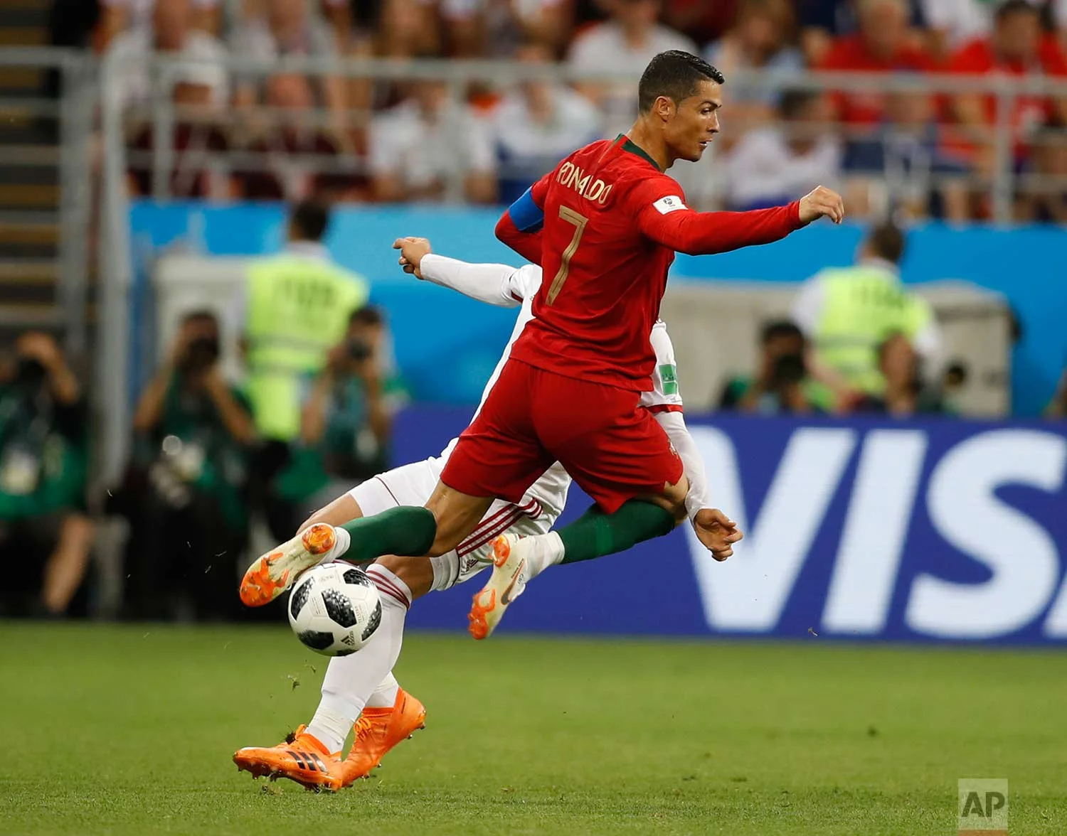 Portugal's Cristiano Ronaldo, collides with Iran's Alireza Jahanbakhsh during the group B match between Iran and Portugal at the 2018 soccer World Cup at the Mordovia Arena in Saransk, Russia, Monday, June 25, 2018. (AP Photo/Francisco Seco)