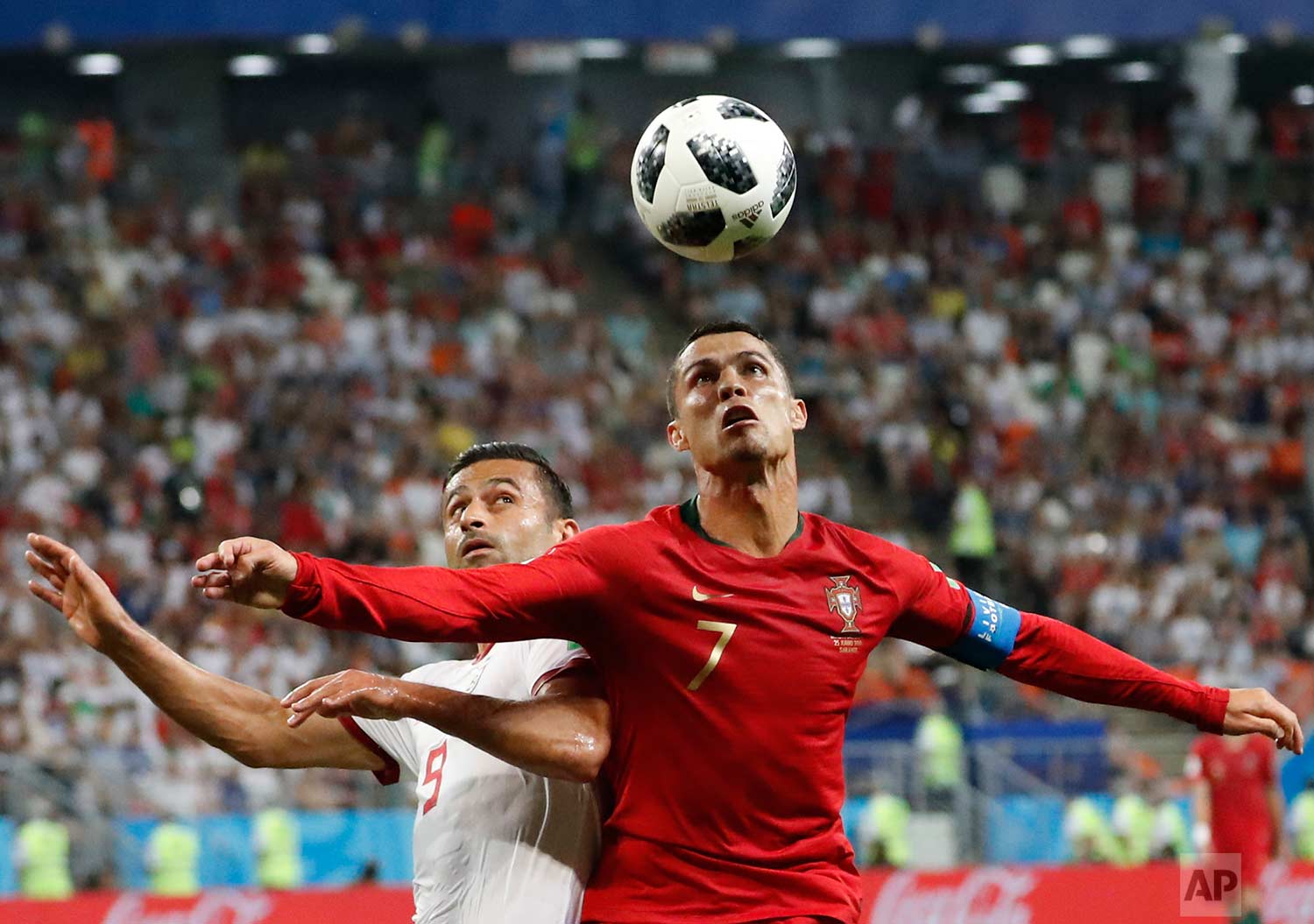 Portugal's Cristiano Ronaldo, right, and Iran's Omid Ebrahimi challenge for the ball during the group B match between Iran and Portugal at the 2018 soccer World Cup at the Mordovia Arena in Saransk, Russia, Monday, June 25, 2018. (AP Photo/Pavel Gol