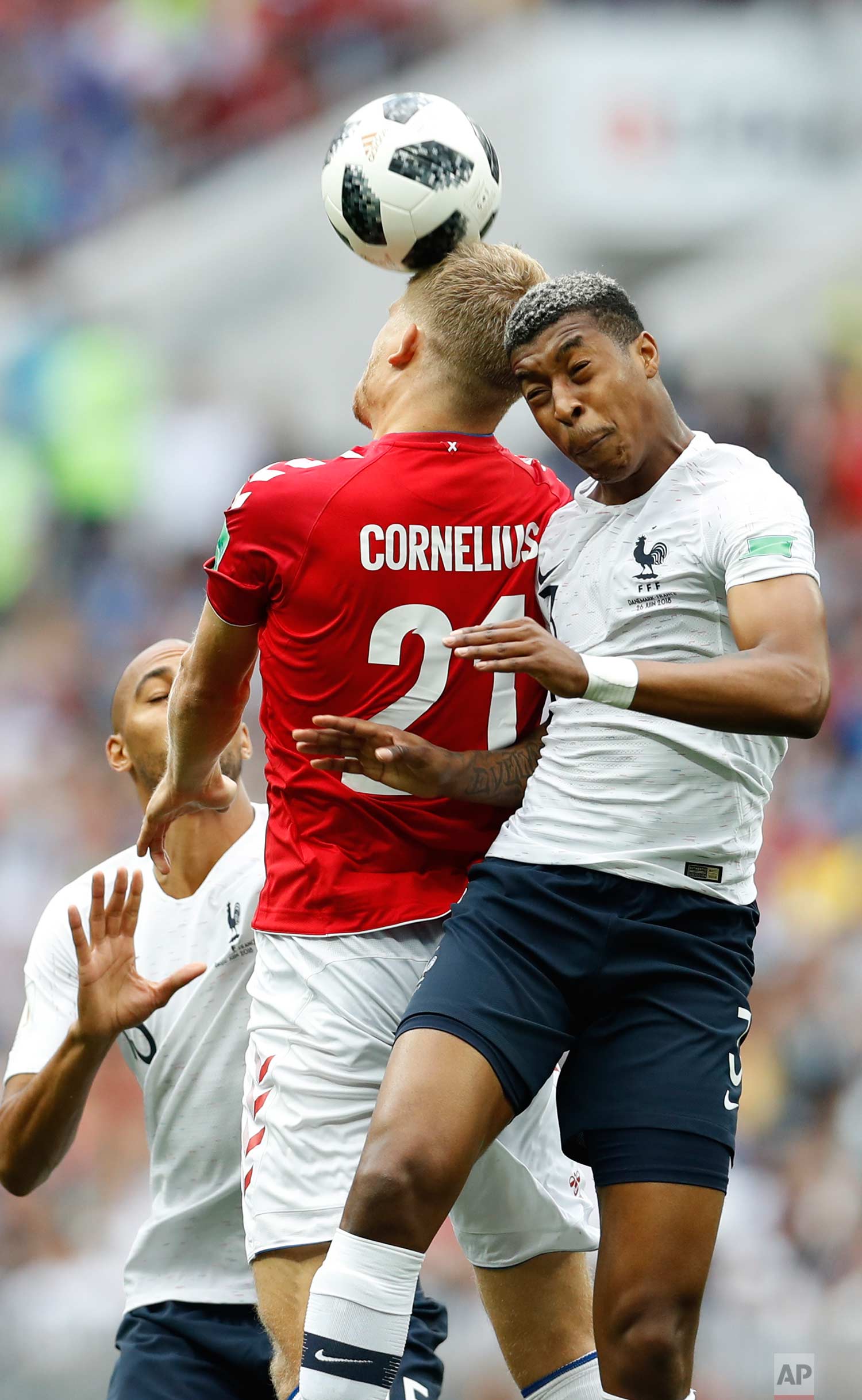  Denmark's Andreas Cornelius goes for a header with France's Presnel Kimpembe during the group C match between Denmark and France at the 2018 soccer World Cup at the Luzhniki Stadium in Moscow, Russia, Tuesday, June 26, 2018. (AP Photo/Antonio Calann