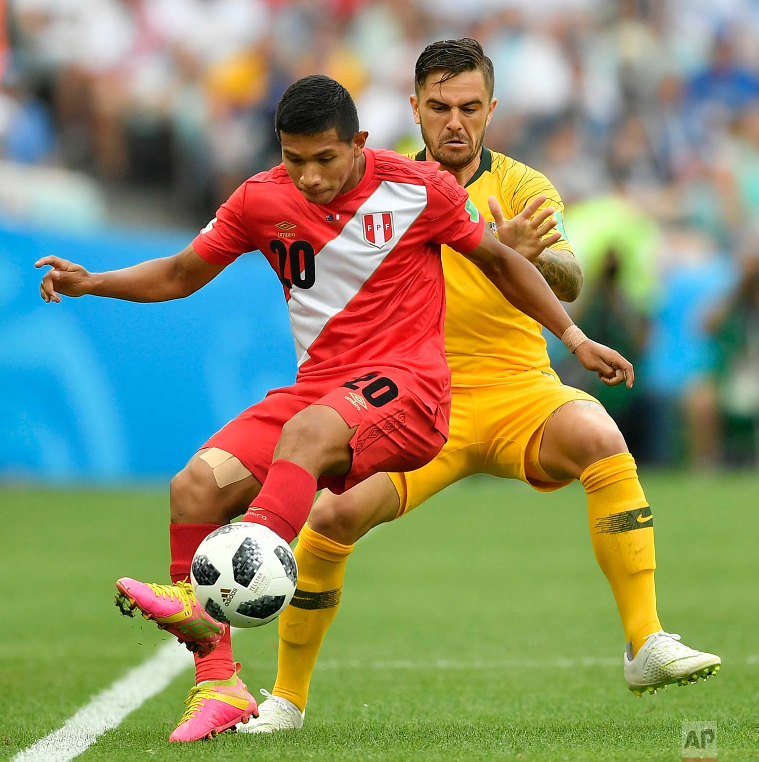  Peru's Edison Flores, left, and Australia's Joshua Risdon challenge for the ball during the group C match between Australia and Peru, at the 2018 soccer World Cup in the Fisht Stadium in Sochi, Russia, Tuesday, June 26, 2018. (AP Photo/Martin Meissn