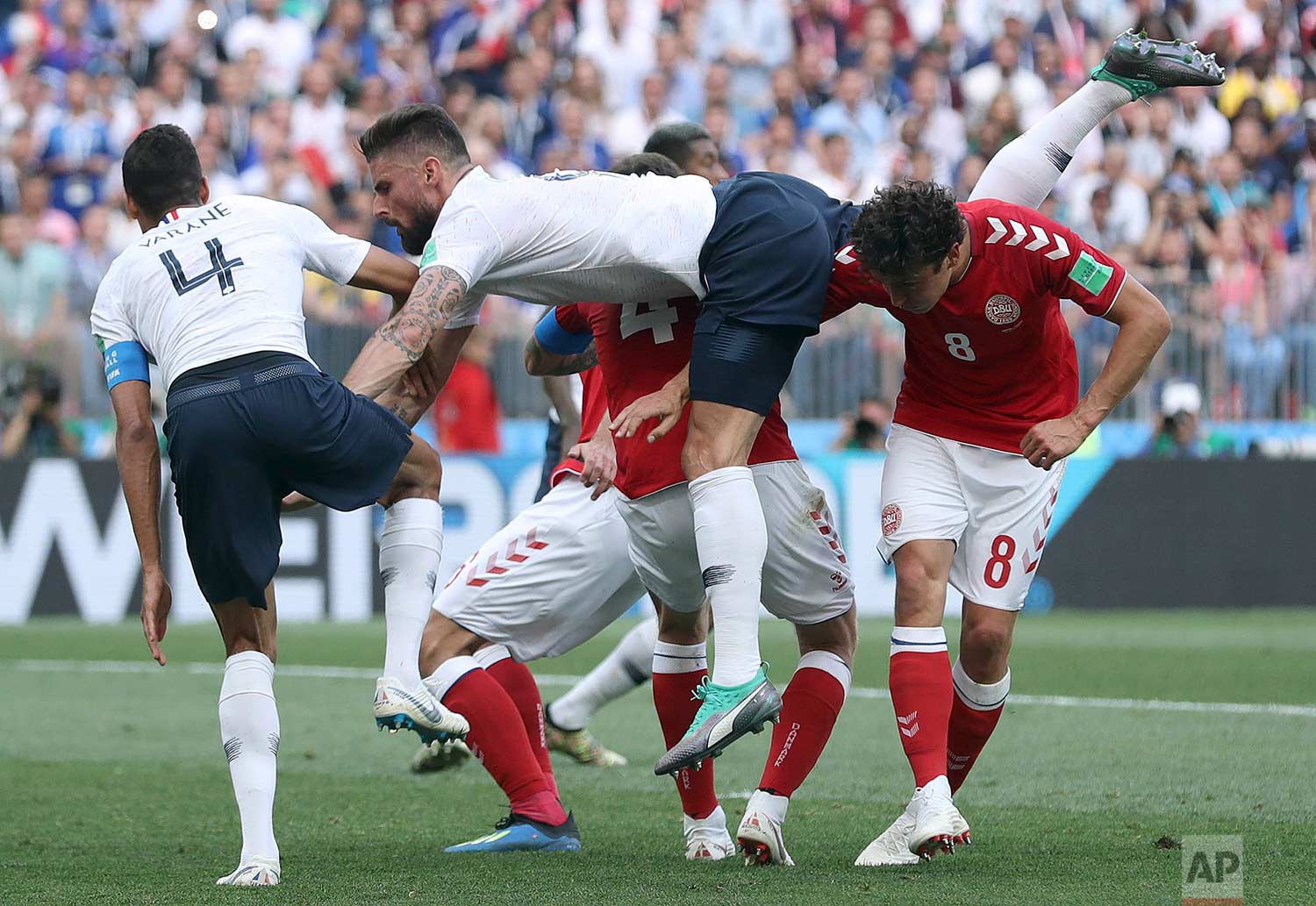  France's Olivier Giroud, center, goes down after a header during the group C match between Denmark and France at the 2018 soccer World Cup at the Luzhniki Stadium in Moscow, Russia, Tuesday, June 26, 2018. (AP Photo/David Vincent) 