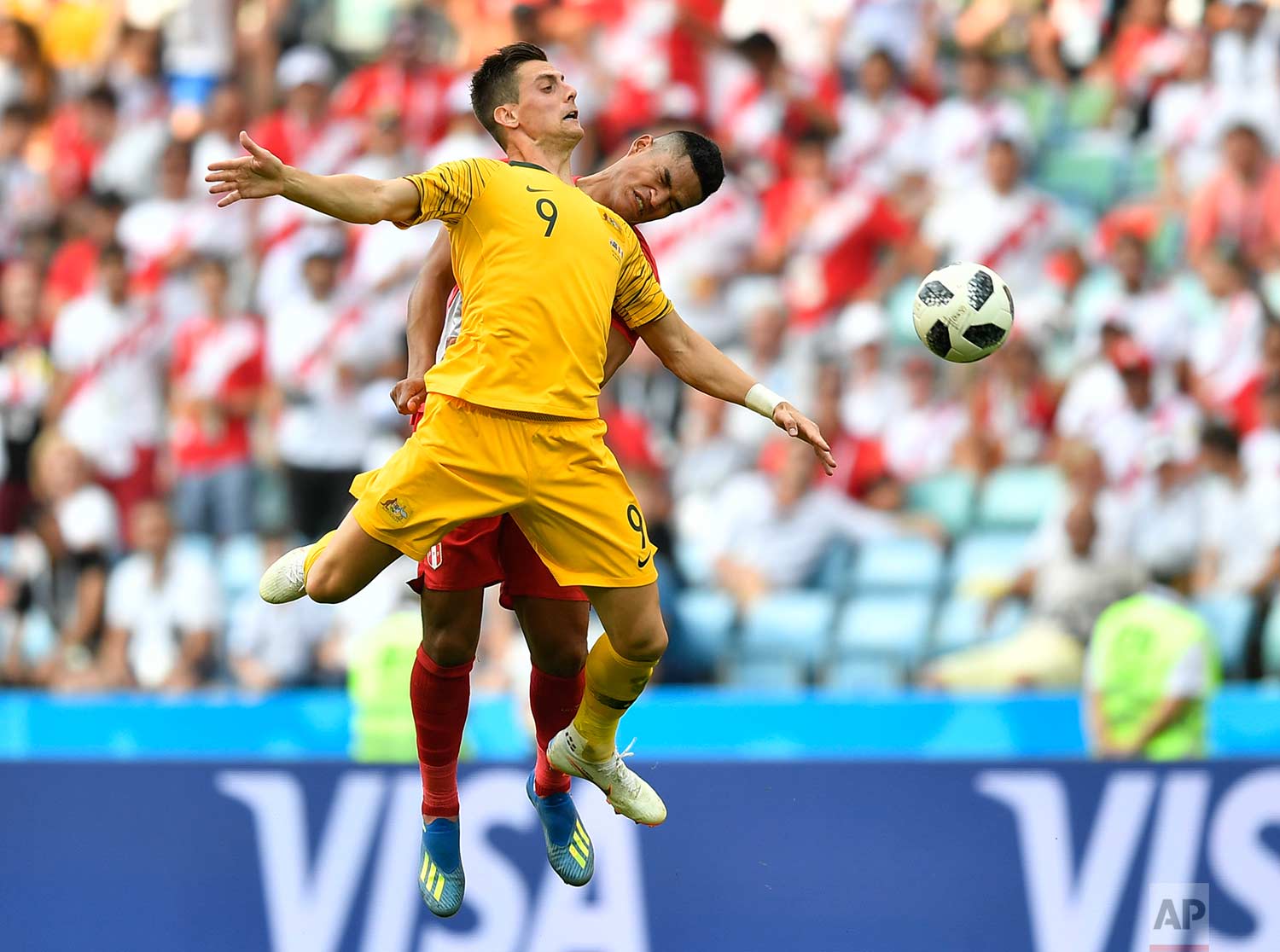  Peru's Anderson Santamaria, background, and Australia's Tomi Juric go for a header during the group C match between Australia and Peru, at the 2018 soccer World Cup in the Fisht Stadium in Sochi, Russia, Tuesday, June 26, 2018. (AP Photo/Martin Meis