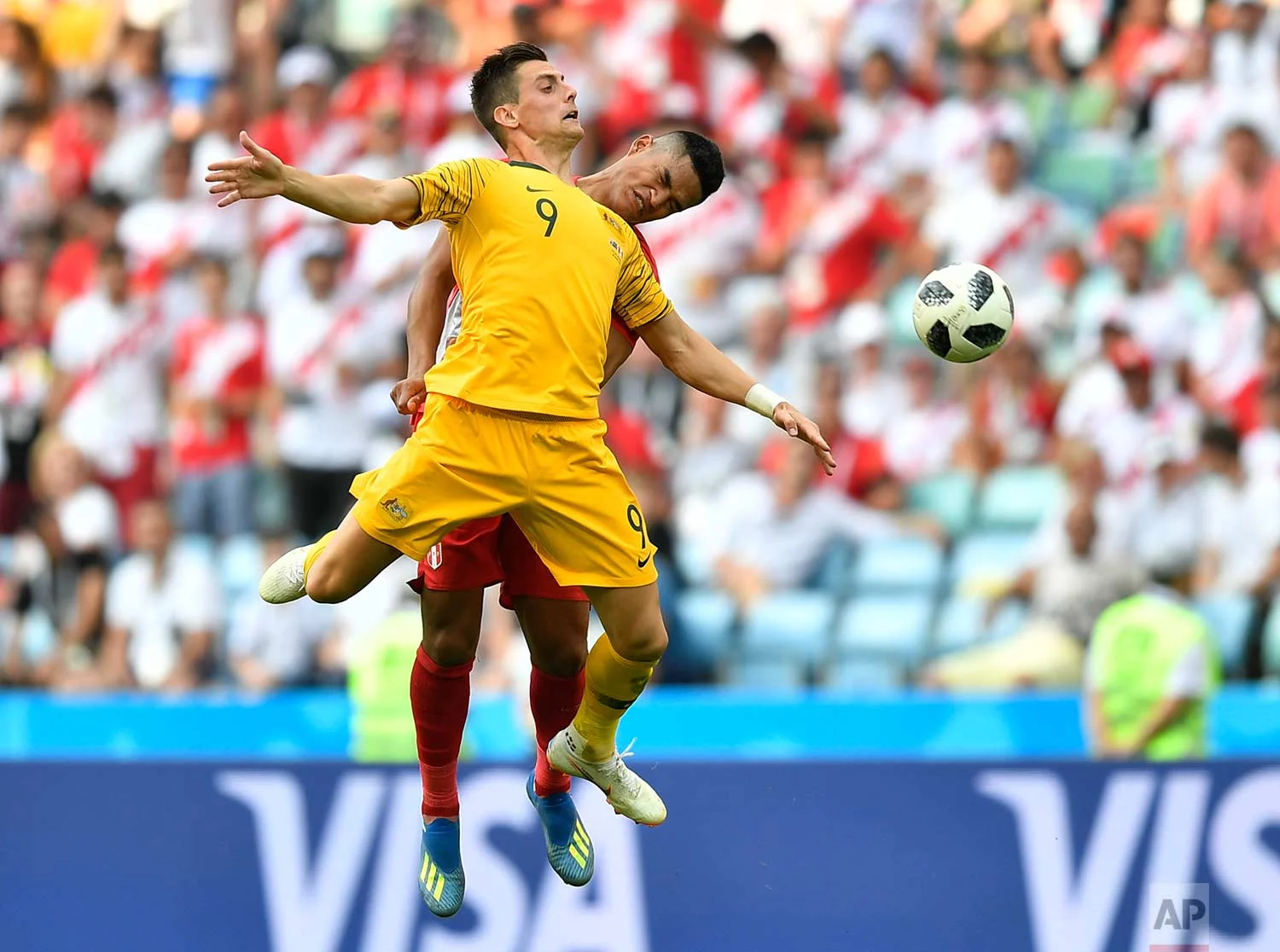 Peru's Anderson Santamaria, background, and Australia's Tomi Juric go for a header during the group C match between Australia and Peru, at the 2018 soccer World Cup in the Fisht Stadium in Sochi, Russia, Tuesday, June 26, 2018. (AP Photo/Martin Meissner)