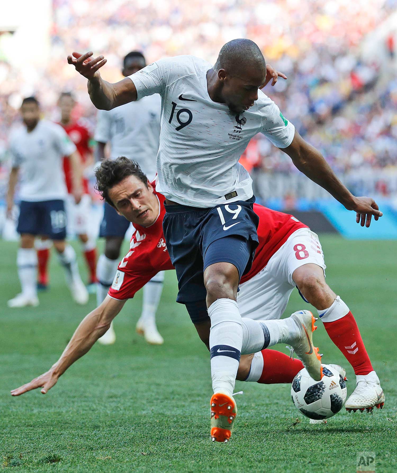  France's Djibril Sidibe, front, and Denmark's Thomas Delaney challenge for the ball during the group C match between Denmark and France at the 2018 soccer World Cup at the Luzhniki Stadium in Moscow, Russia, Tuesday, June 26, 2018. (AP Photo/David V