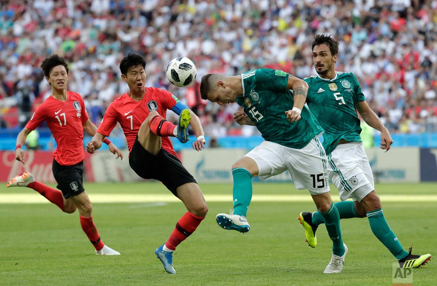 South Korea's Son Heung-min, 2nd left, challenges for the ball Germany's Niklas Suele, 2nd right, during the group F match between South Korea and Germany, at the 2018 soccer World Cup in the Kazan Arena in Kazan, Russia, Wednesday, June 27, 2018. (AP Photo/Lee Jin-man)