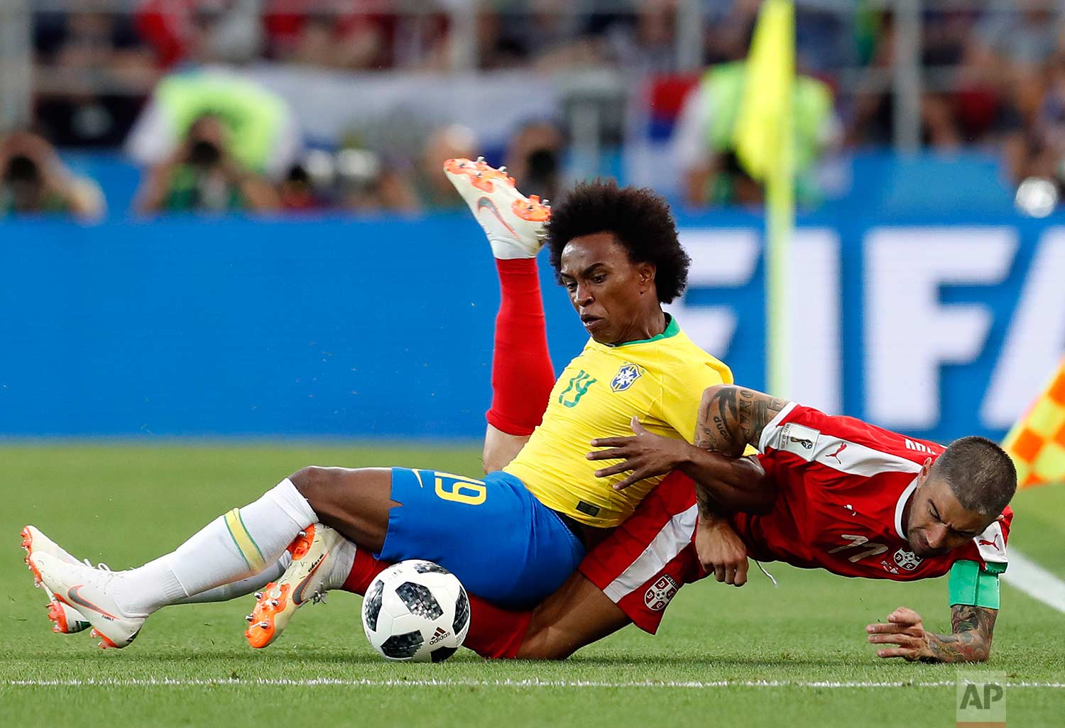 Brazil's Willian, left, and Serbia's Aleksandar Kolarov battle for the ball during the group E match between Serbia and Brazil, at the 2018 soccer World Cup in the Spartak Stadium in Moscow, Russia, Wednesday, June 27, 2018. (AP Photo/Rebecca Blackwell)