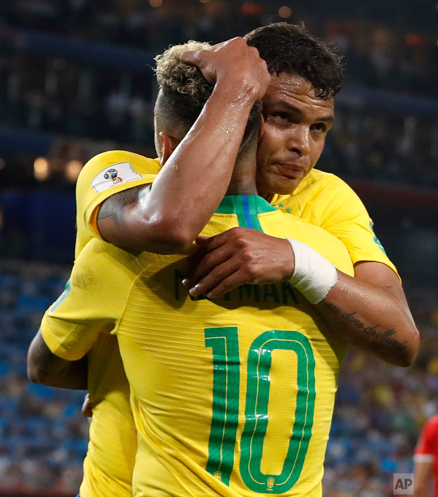 Brazil's Thiago Silva, face to camera, celebrates with teammate Neymar after scoring his side's second goal during the group E match between Serbia and Brazil, at the 2018 soccer World Cup in the Spartak Stadium in Moscow, Russia, Wednesday, June 27, 2018. (AP Photo/Rebecca Blackwell)