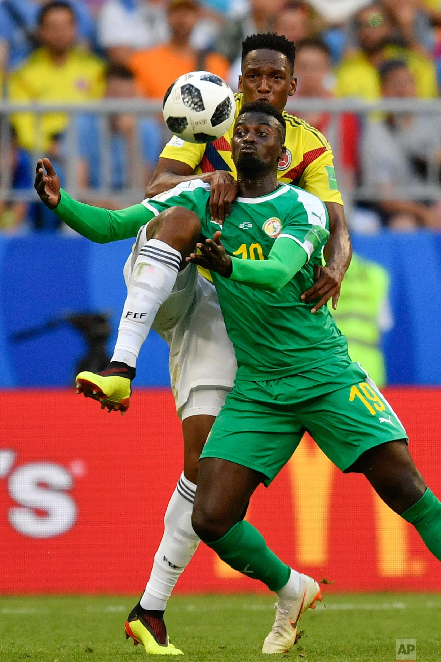 Senegal's Mbaye Niang, bottom, vies for the ball with Colombia's Oscar Murillo, top, during the group H match between Senegal and Colombia, at the 2018 soccer World Cup in the Samara Arena in Samara, Russia, Thursday, June 28, 2018. (AP Photo/Martin Meissner)