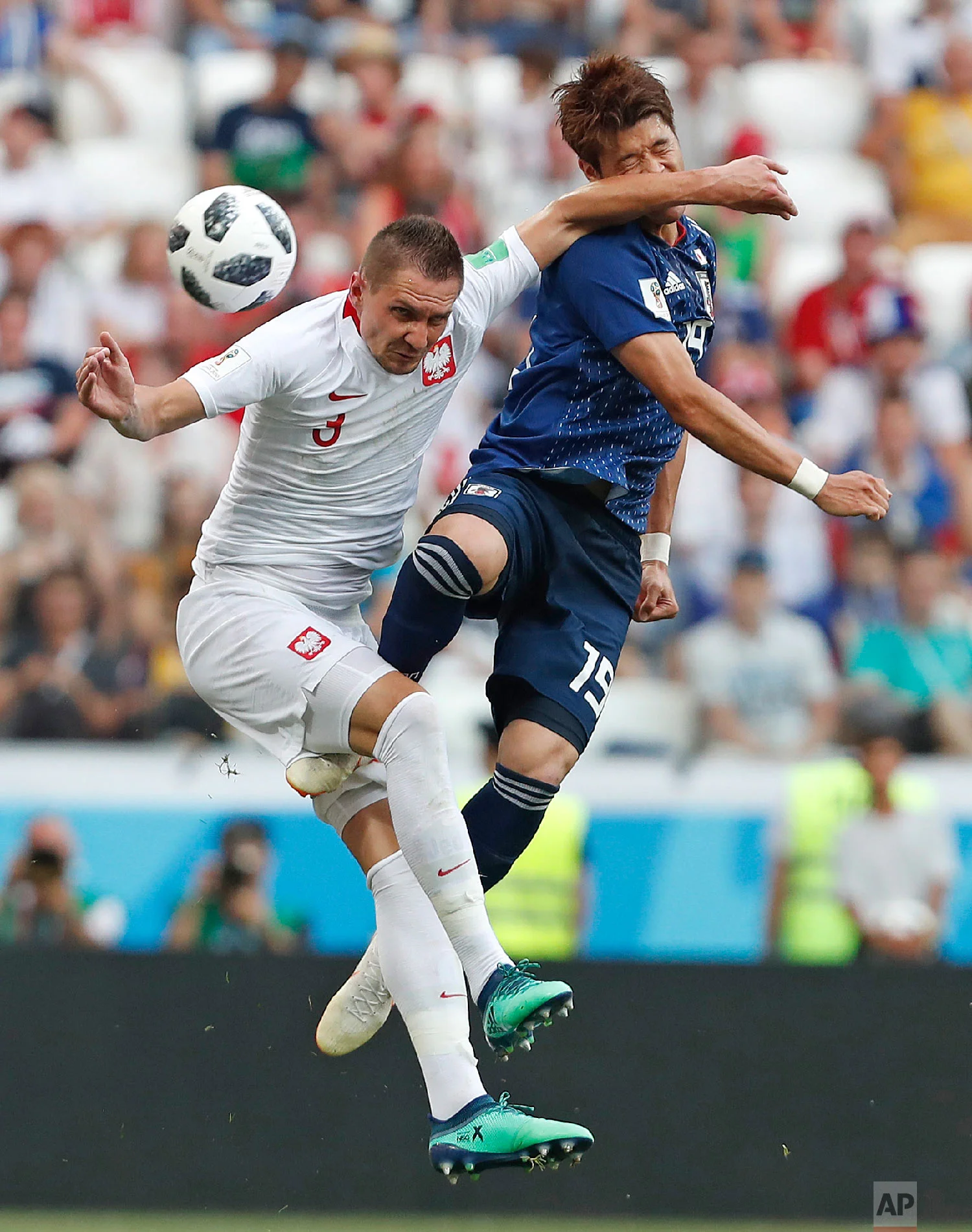 Poland's Artur Jedrzejczyk, left, challenges Japan's Hiroki Sakai during the group H match between Japan and Poland at the 2018 soccer World Cup at the Volgograd Arena in Volgograd, Russia, Thursday, June 28, 2018. (AP Photo/Darko Vojinovic)