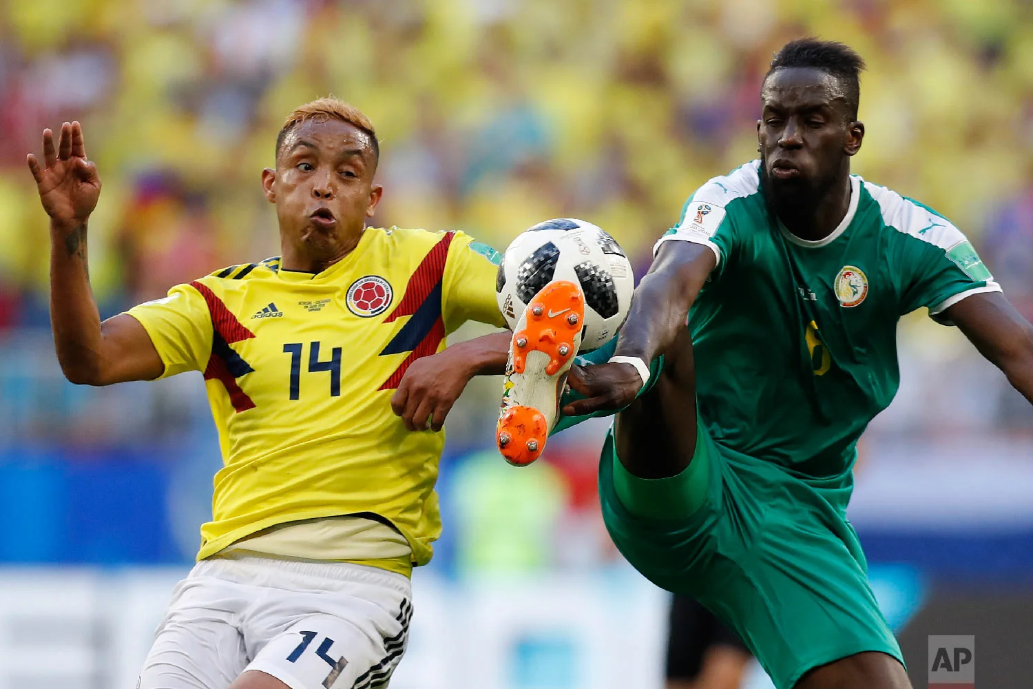 Colombia's Luis Muriel, left, and Senegal's Salif Sane challenge for the ball during the group H match between Senegal and Colombia, at the 2018 soccer World Cup in the Samara Arena in Samara, Russia, Thursday, June 28, 2018. (AP Photo/Efrem Lukatsky)