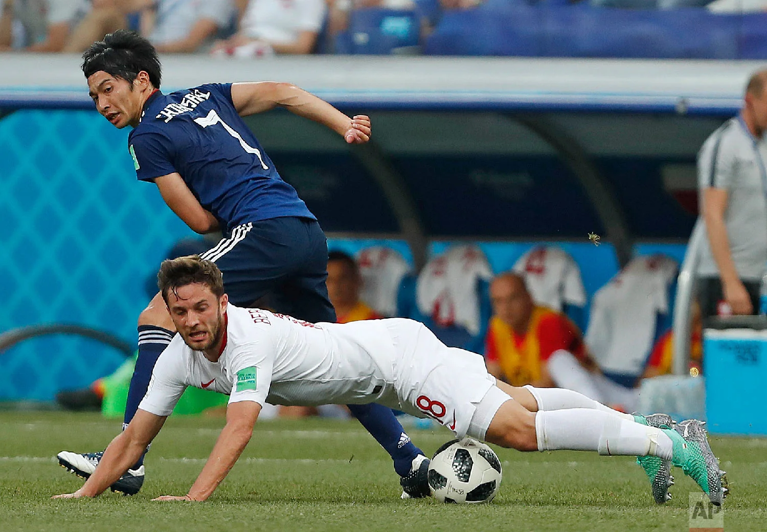 Poland's Bartosz Bereszynski, front, is challenged by Japan's Gaku Shibasaki during the group H match between Japan and Poland at the 2018 soccer World Cup at the Volgograd Arena in Volgograd, Russia, Thursday, June 28, 2018. (AP Photo/Darko Vojinovic)