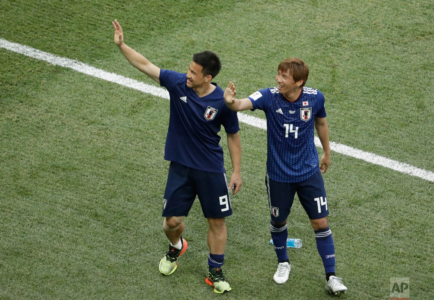 Japan's Shinji Okazaki and Takashi Inui, right, wave to the stands at the end of the group H match between Japan and Poland at the 2018 soccer World Cup at the Volgograd Arena in Volgograd, Russia, Thursday, June 28, 2018. (AP Photo/Themba Hadebe)