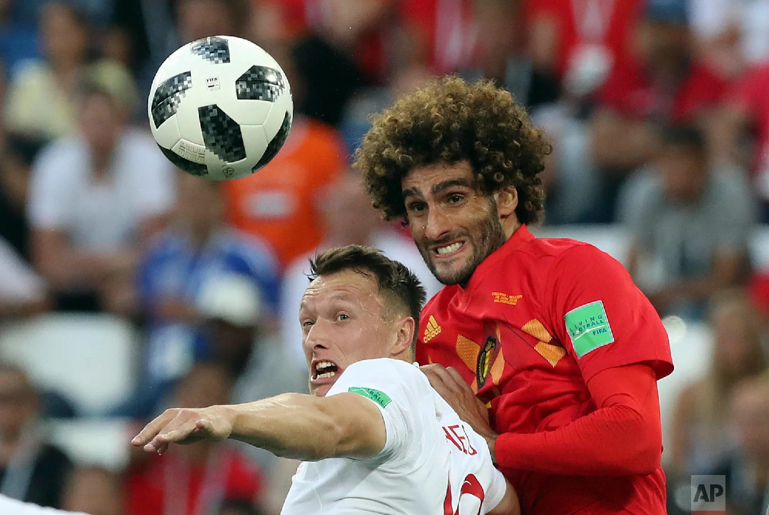 England's Ashley Young, left, and Belgium's Marouane Fellaini challenge for the ball during the group G match between England and Belgium at the 2018 soccer World Cup in the Kaliningrad Stadium in Kaliningrad, Russia, Thursday, June 28, 2018. (AP Photo/Czarek Sokolowski)