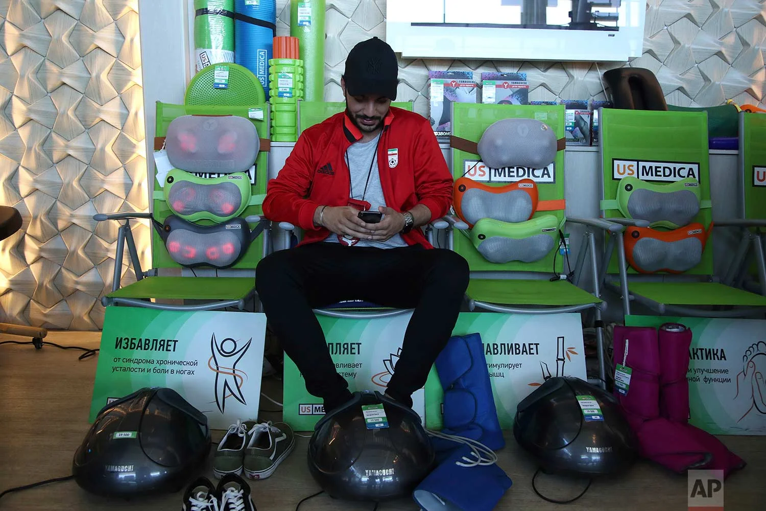 In this Friday, June 22, 2018 photo, an Iranian fan enjoys a foot massage at a shop at Kazan International Airport in Kazan, Russia. (AP Photo/Thanassis Stavrakis)