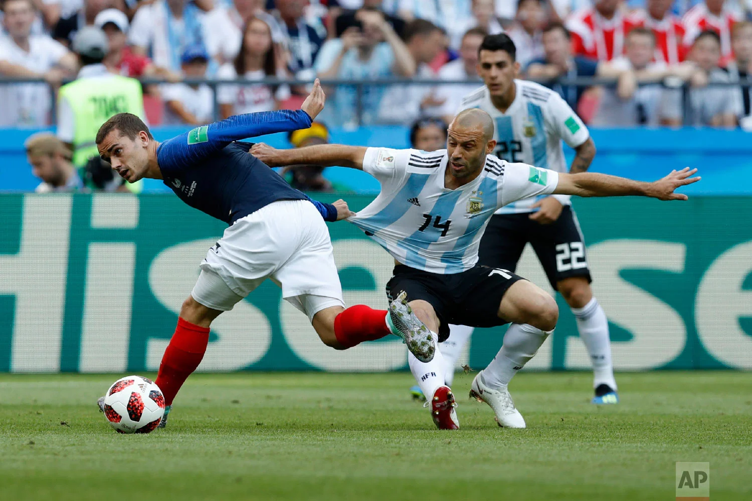 France's Antoine Griezmann, left, and Argentina's Javier Mascherano challenge for the ball during the round of 16 match between France and Argentina, at the 2018 soccer World Cup at the Kazan Arena in Kazan, Russia, Saturday, June 30, 2018. (AP Photo/David Vincent)