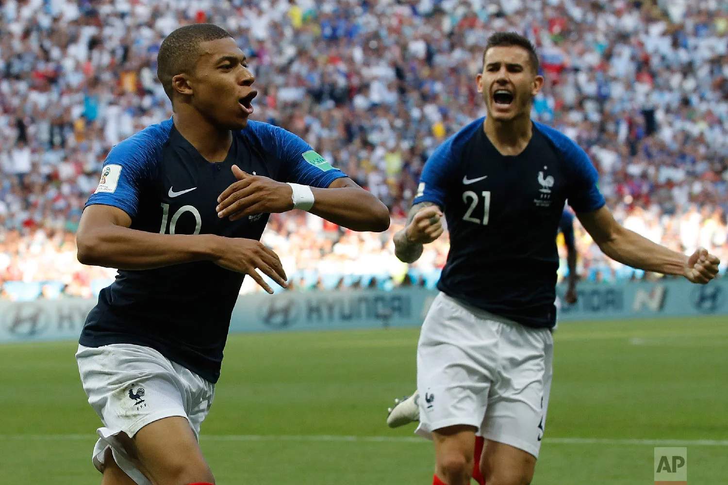 France's Kylian Mbappe, left, celebrates with team mate Lucas Hernandez after scoring his side's third goal during the round of 16 match between France and Argentina, at the 2018 soccer World Cup at the Kazan Arena in Kazan, Russia, Saturday, June 30, 2018. (AP Photo/David Vincent)