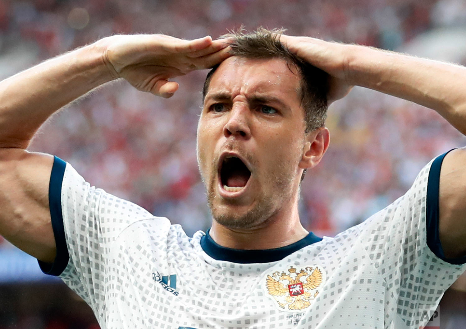  Russia's Artyom Dzyuba salutes when celebrating scoring his side's opening goal during the round of 16 match between Spain and Russia at the 2018 soccer World Cup at the Luzhniki Stadium in Moscow, Russia, Sunday, July 1, 2018. (AP Photo/Antonio Cal