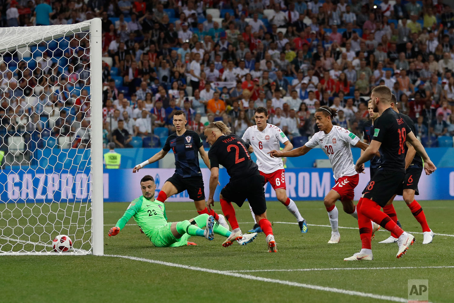  Croatia goalkeeper Danijel Subasic, left on the pitch, looks at the ball after Denmark's Mathias Jorgensen scored the opening goal during the round of 16 match between Croatia and Denmark at the 2018 soccer World Cup in the Nizhny Novgorod Stadium, 