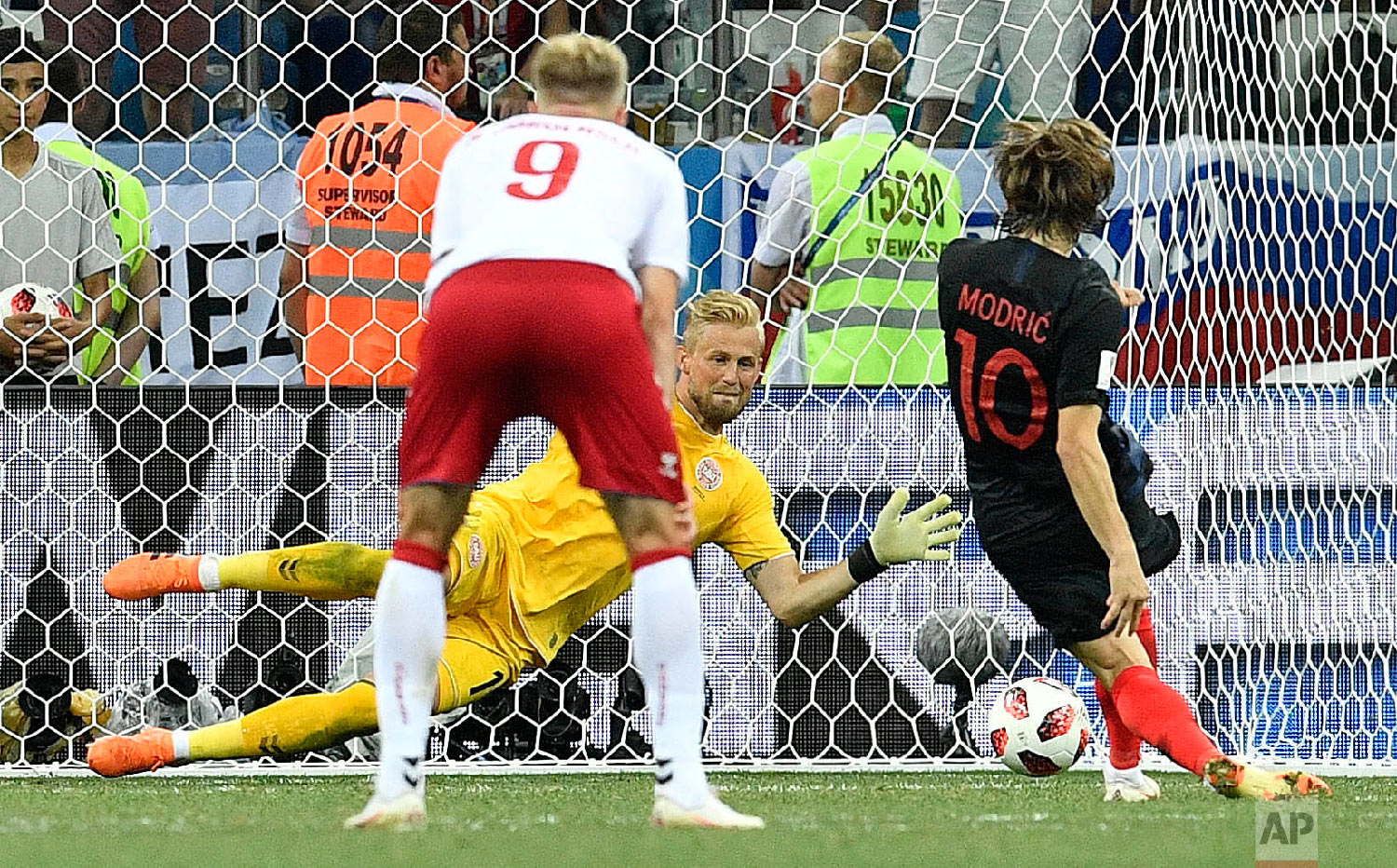 Denmark goalkeeper Kasper Schmeichel saves the penalty kick by Croatia's Luka Modric during the round of 16 match between Croatia and Denmark at the 2018 soccer World Cup in the Nizhny Novgorod Stadium, in Nizhny Novgorod , Russia, Sunday, July 1, 2018. (AP Photo/Martin Meissner)