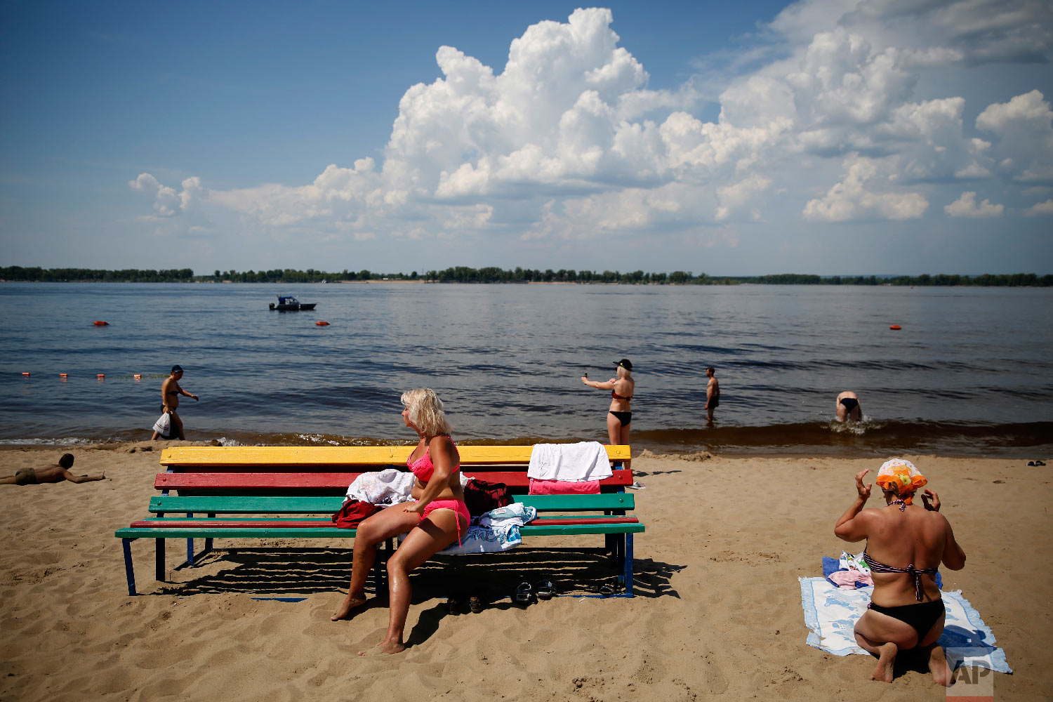  People spend a sunny day on a riverfront beach, during the 2018 soccer World Cup in Samara, Russia on June 26, 2018. (AP Photo/Rebecca Blackwell) 