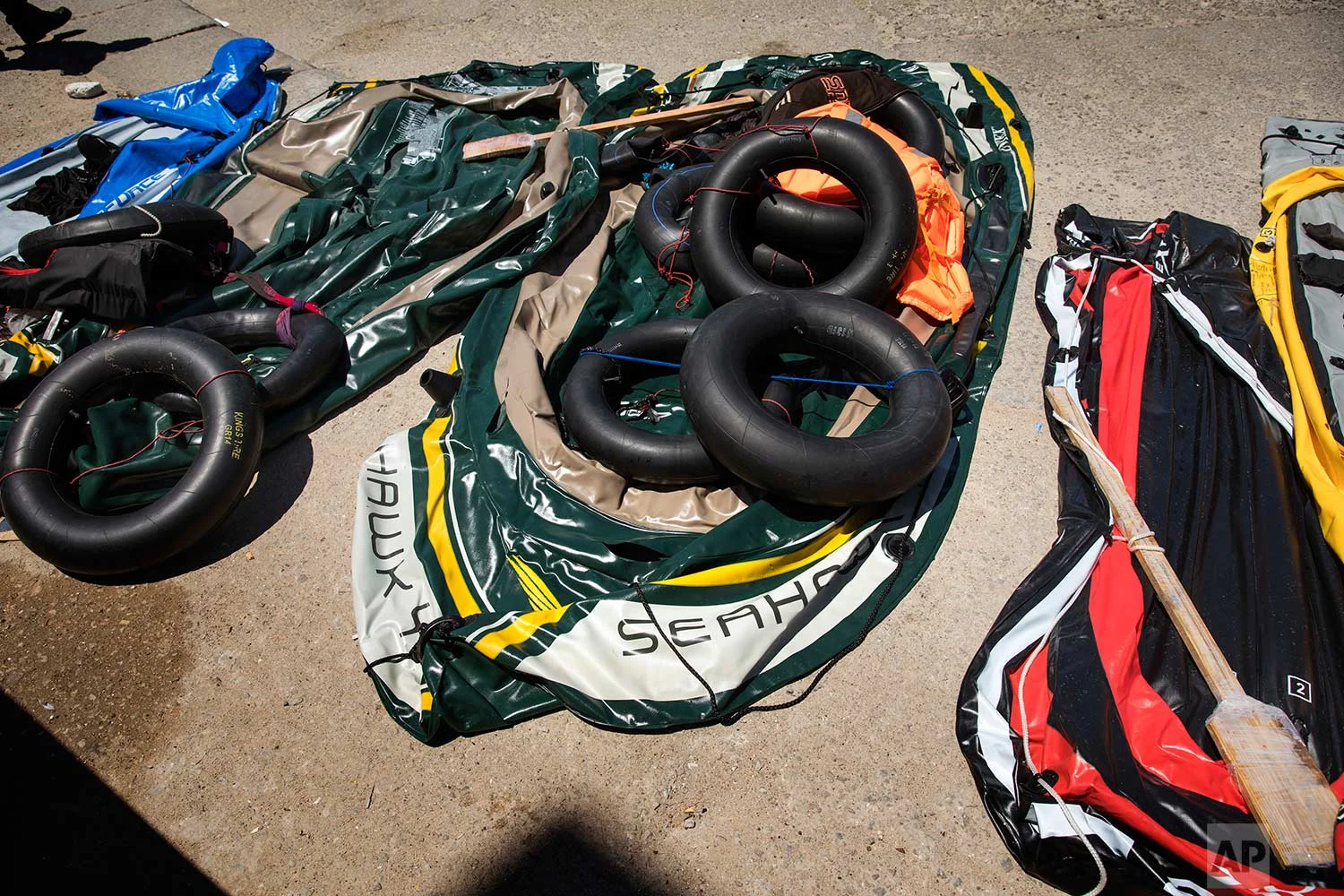 Inflatable dinghies and tires used as floats by migrants are seen at the port of Tarifa, southern Spain, after being rescued by Spain's Maritime Rescue Service in the Strait of Gibraltar, Friday, June 29, 2018. European Union leaders declared victory Friday, claiming to have set aside major differences over how best to handle migrant arrivals as they commissioned new plans to screen people in North Africa for eligibility to enter Europe. (AP Photo/Emilio Morenatti)