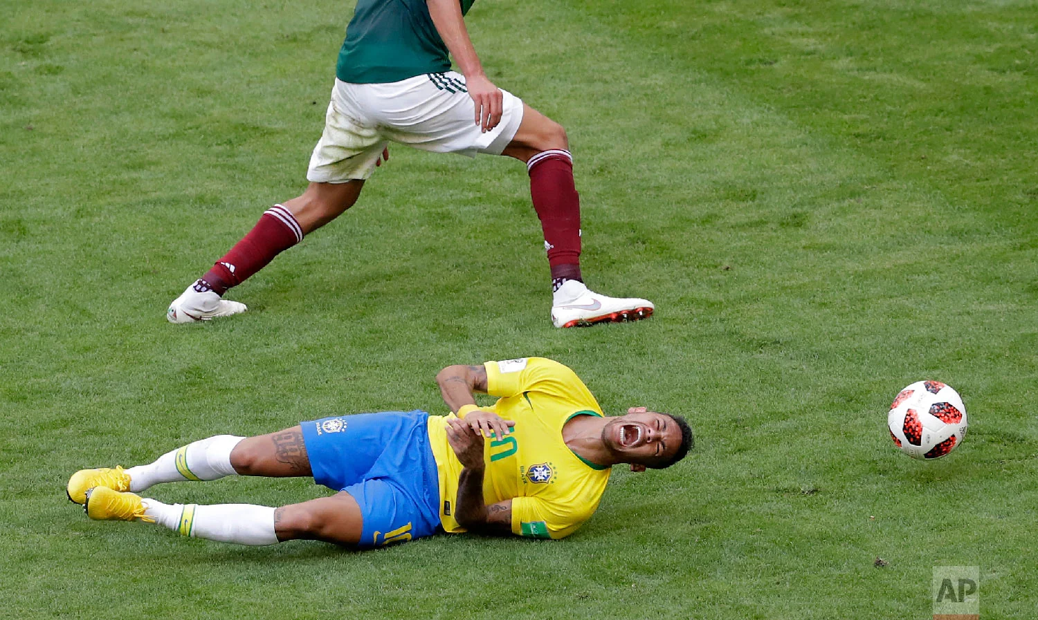 Brazil's Neymar, bottom, challenges for the ball with Mexico's Edson Alvarez during the round of 16 match between Brazil and Mexico at the 2018 soccer World Cup in the Samara Arena, in Samara, Russia, Monday, July 2, 2018. (AP Photo/Sergei Grits)