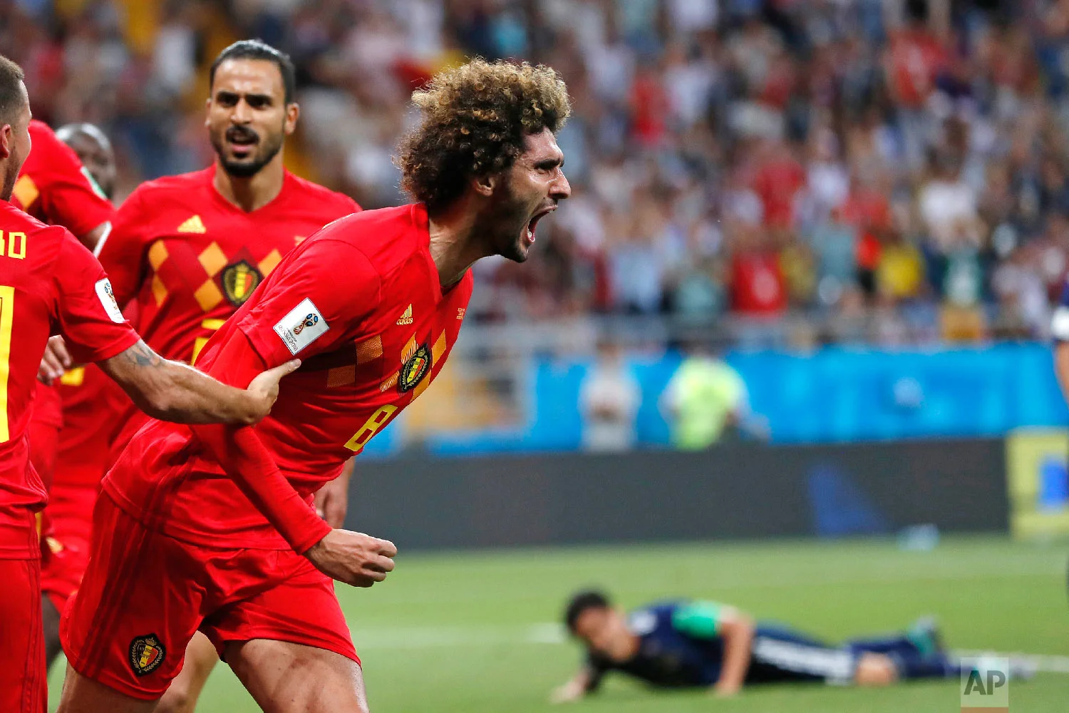 Belgium's Marouane Fellaini celebrates after scoring his side's second goal during the round of 16 match between Belgium and Japan at the 2018 soccer World Cup in the Rostov Arena, in Rostov-on-Don, Russia, Monday, July 2, 2018. (AP Photo/Natacha Pisarenko)