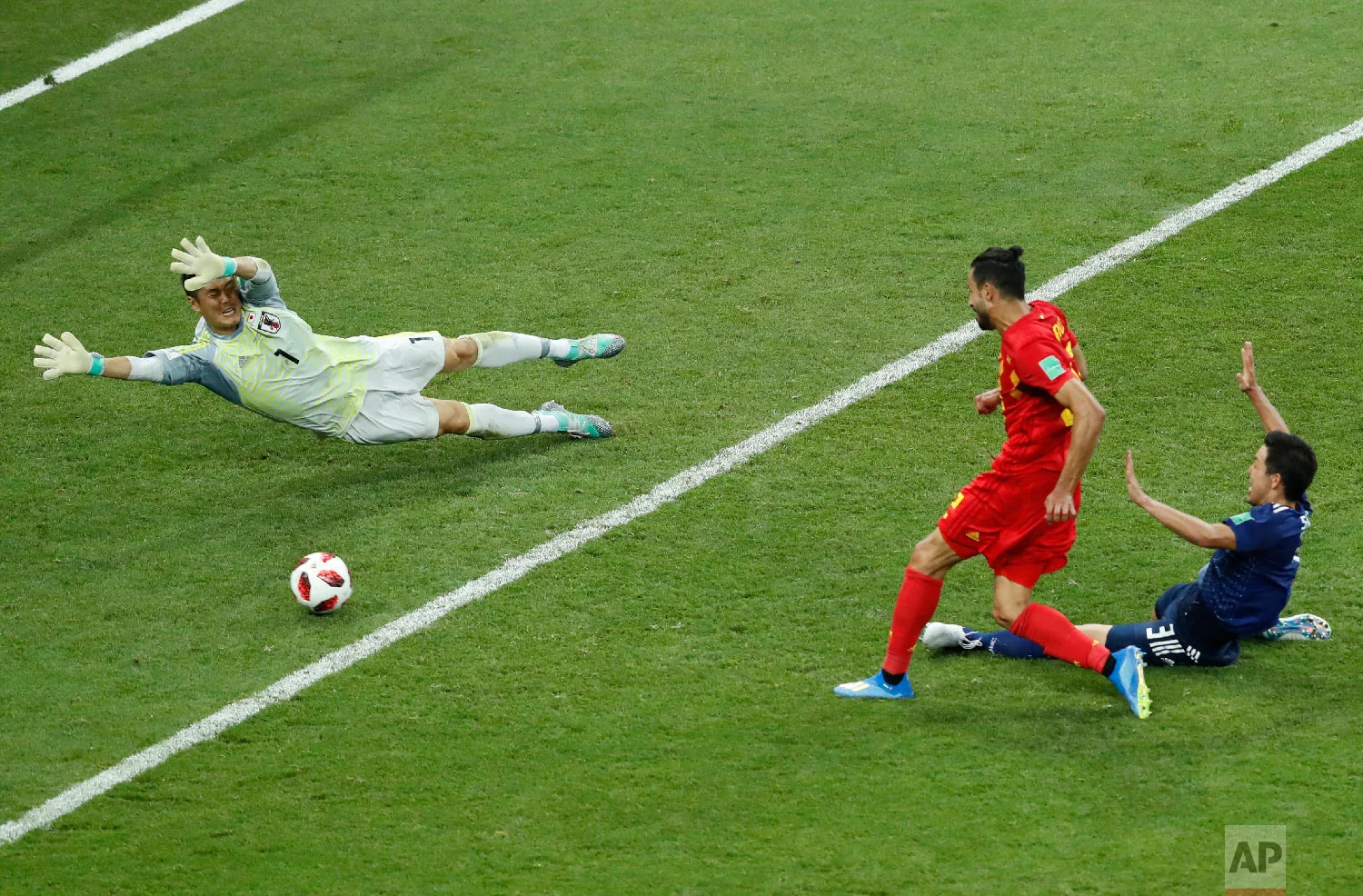 Belgium's Nacer Chadli, center, scores his third side goal during the round of 16 match between Belgium and Japan at the 2018 soccer World Cup in the Rostov Arena, in Rostov-on-Don, Russia, Monday, July 2, 2018. (AP Photo/Hassan Ammar)