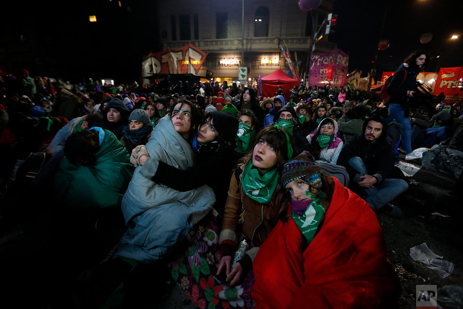  Women watch a live broadcast of the debate by the lower house of Congress over an abortion law in Buenos Aires, June 14, 2018. The lower house approved the bill that would legalize elective abortion in the first 14 weeks of pregnancy, sending the me