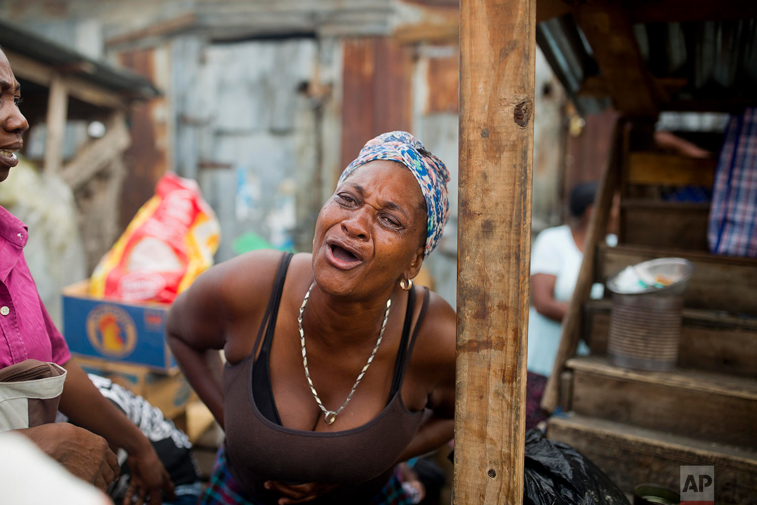  A woman cries after a fire wiped out her stall at a rice and beans market in Port-au-Prince, Haiti, June 12, 2018. The entire market, where vendors sell rice, black beans, onions and other grains and perishables was destroyed. (AP Photo/Dieu Nalio C